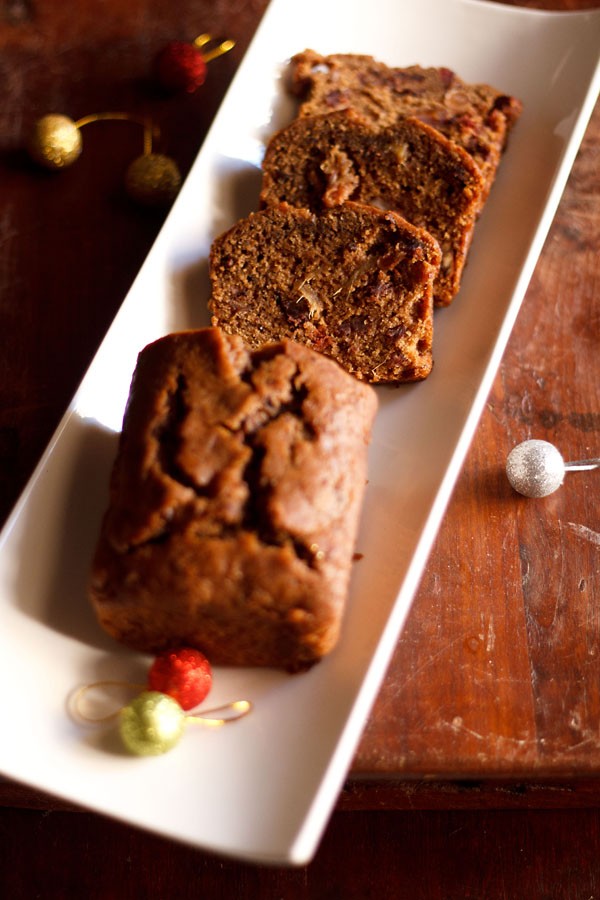 wine cake sliced and served on a white platter. 