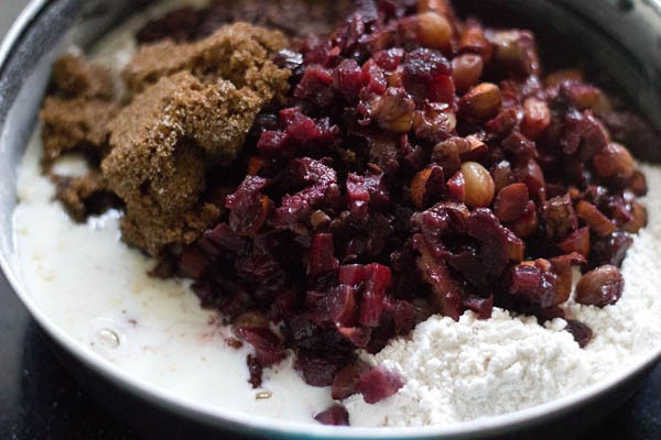 soaked nuts and dry fruits, brown sugar and dissolved curd added to flour mixture. 