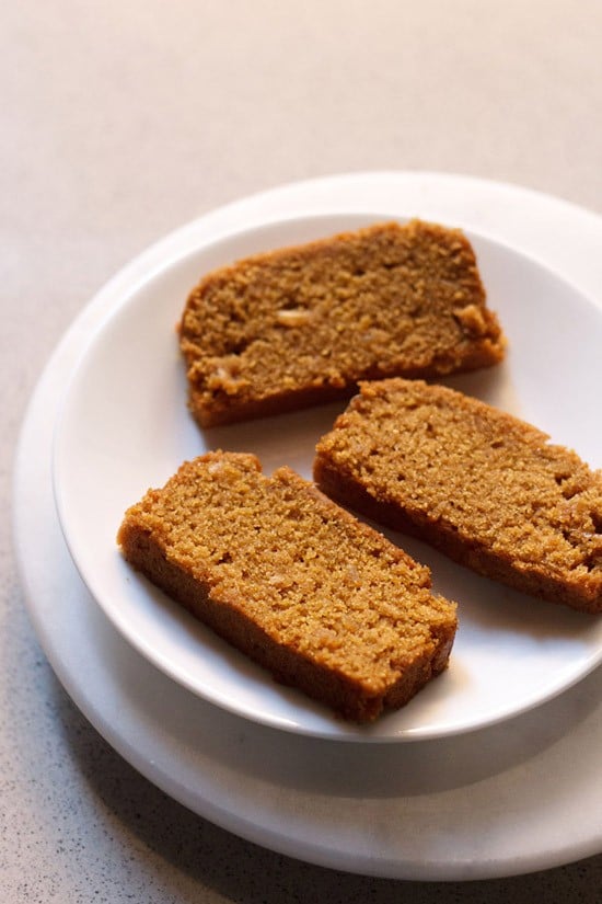 three slices of eggless gingerbread cake on a white plate.