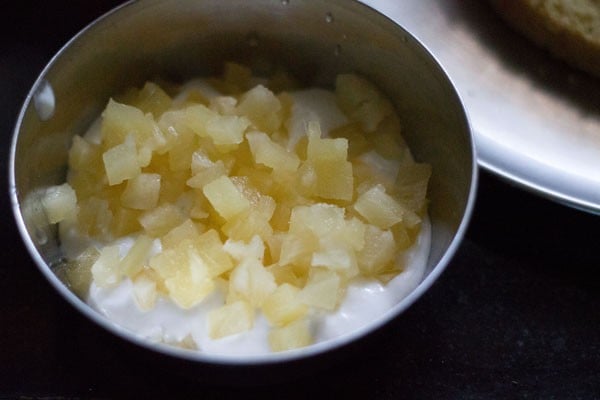 add chopped pineapple pieces to whipped cream.