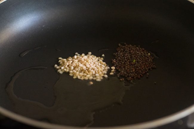 mustard seeds and urad dal added to pan with oil