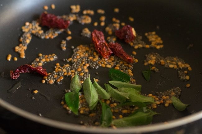 dry red chilies and curry leaves added to urad dal mixture