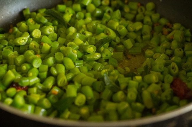 cooking french beans poriyal in the pan