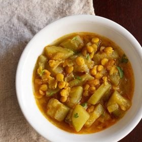 lauki chana dal served in a white bowl.