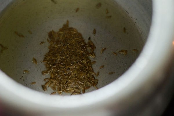 oil and cumin seeds in pressure cooker