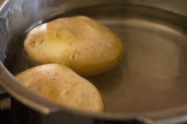 Boil potatoes for potato pod recipe. 