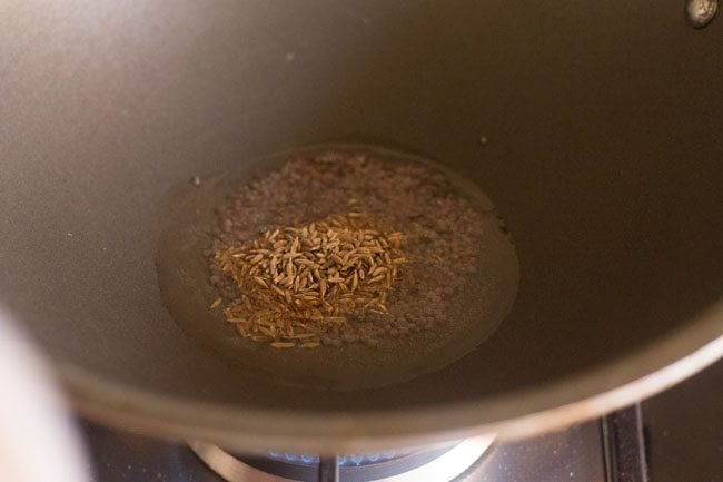 Add cumin seeds to hot oil. 