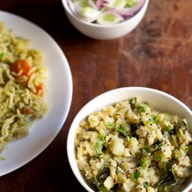 potato podimas served in a white bowl with a plate of masala rice and a small bowl of cucumber and onions kept with it.