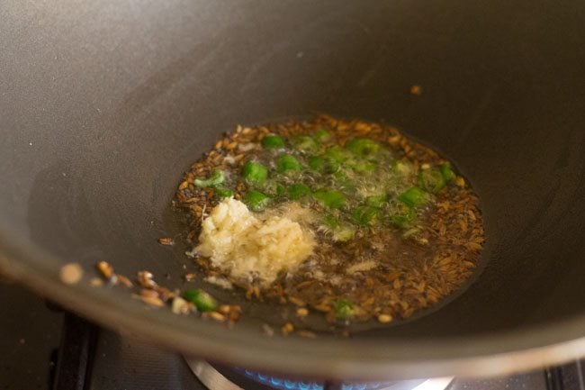 Add chopped green chillies and grated ginger to the spices. 