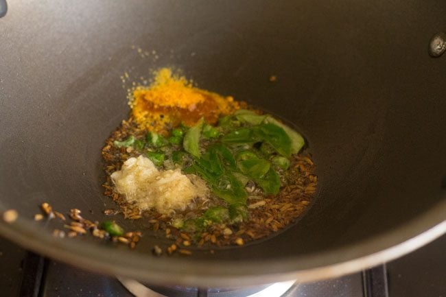 Add curry leaves, turmeric powder and asafoetida to the oil. 