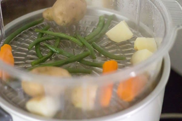 boiling potato, carrot and french beans for making filling for sesame toast. 