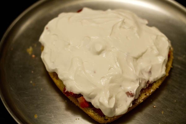 whipped cream on top of the strawberry filling