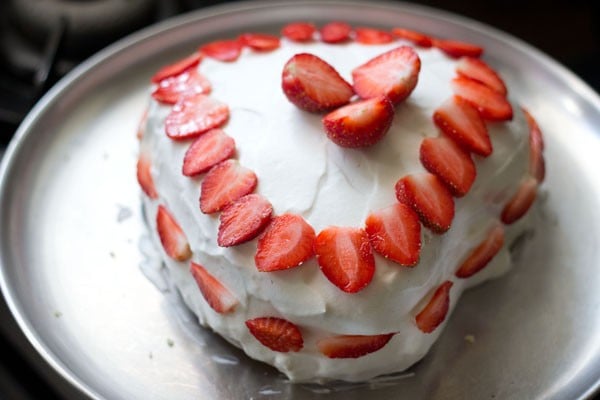 strawberry cream cake decorated with sliced strawberries