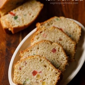 eggless tutti frutti cake served on a white plate.