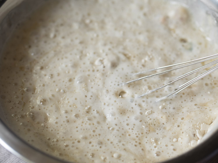 mixing the flour with curd and sugar solution