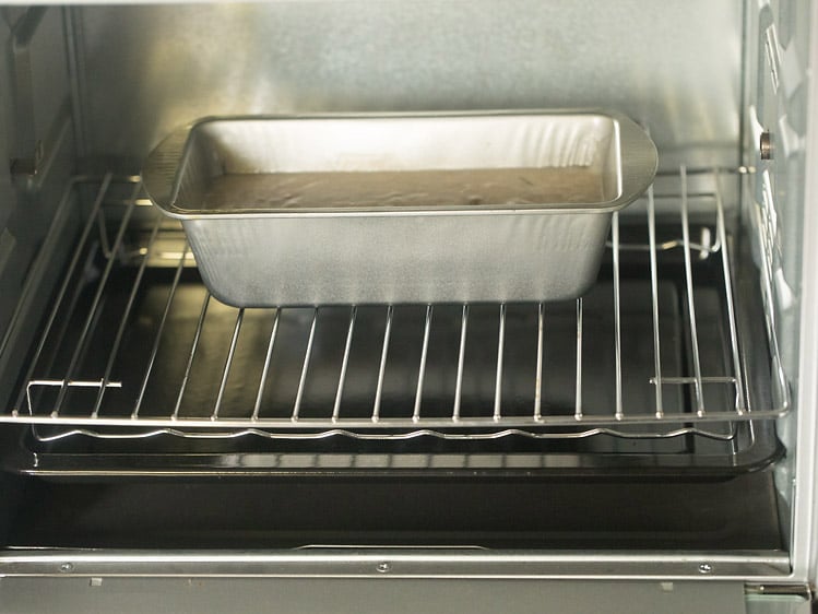 cake pan with batter placed in oven