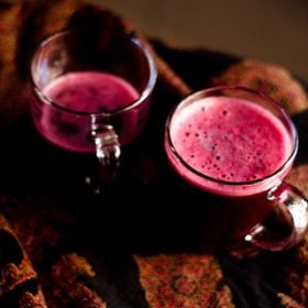 black grapes juice in two glass mugs.