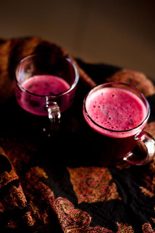 black grapes juice in two glass mugs.