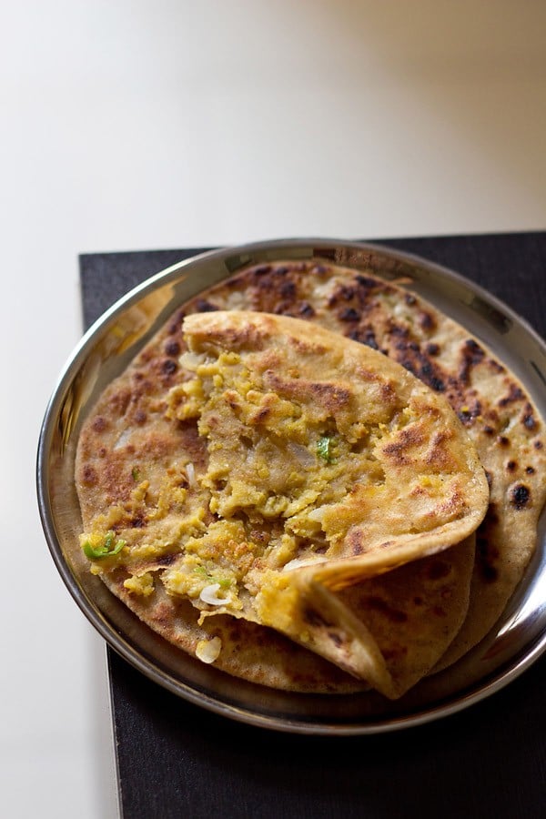 dal paratha served on a plate.