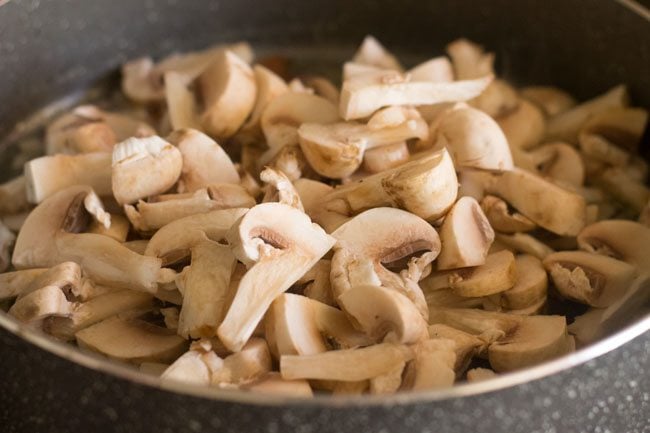 chopped button mushrooms in pot