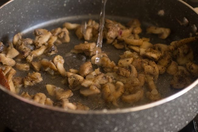 adding water to the pot with mushrooms