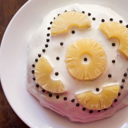 top shot of pineapple pastry cake on white plate.