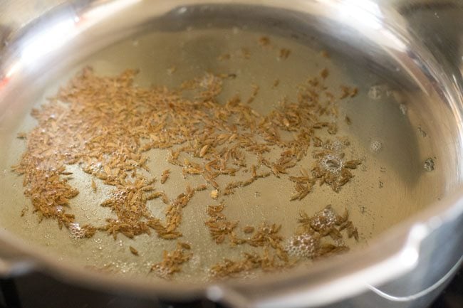 cumin added to ghee in pan