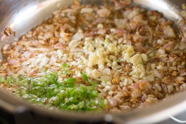 chopped garlic and chiles added to onions for making kala chana curry recipe