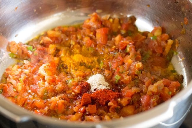 spices added to onion-tomato masala for making kala chana gravy