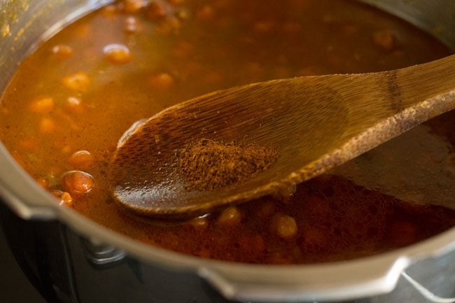 garam masala being added to kala chana recipe,
