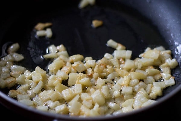 sautéing potatoes in oil till light golden for kanda batata poha. 