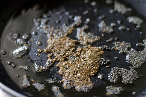 cumin seeds getting fried in oil