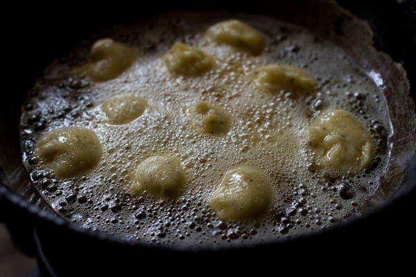 frying moong dal pakodas in hot oil. 