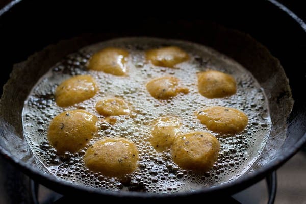 frying moong dal pakodas in hot oil. 