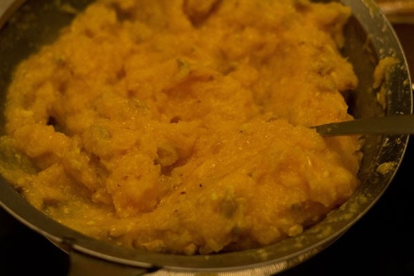 straining juice from the crushed orange pulp. 