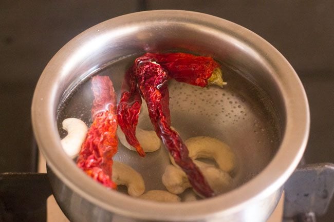 cashews and dried kashmiri red chilies soaking in water.