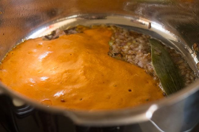 masala paste added to pot with onions and tempering.