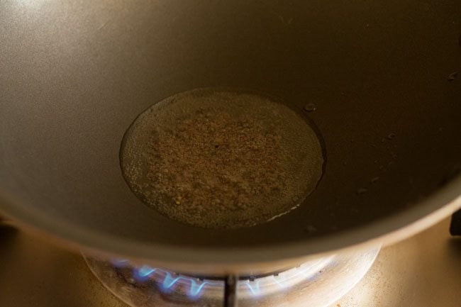 mustard seeds crackling in hot oil in a  pan. 