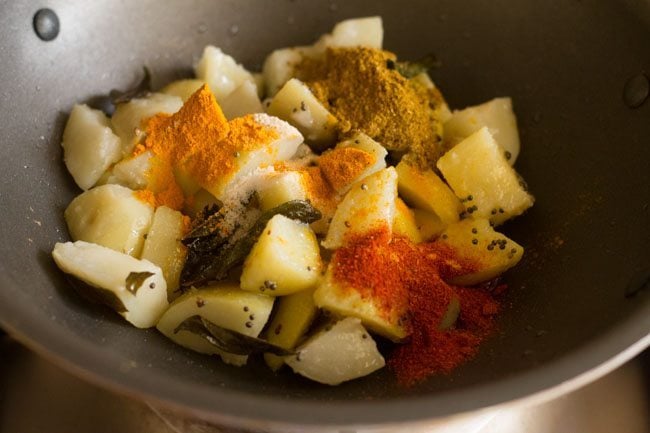 spice powders, asafoetida and salt added to the potatoes. 