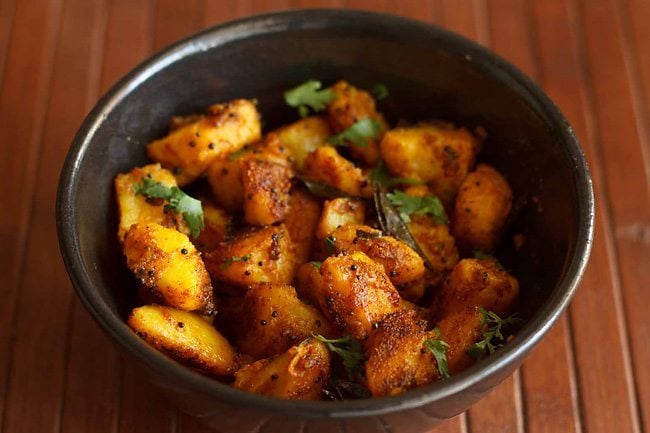 cooked potato roast garnished with coriander leaves. 