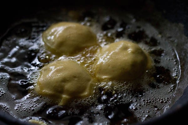 frying aloo bonda in hot oil. 