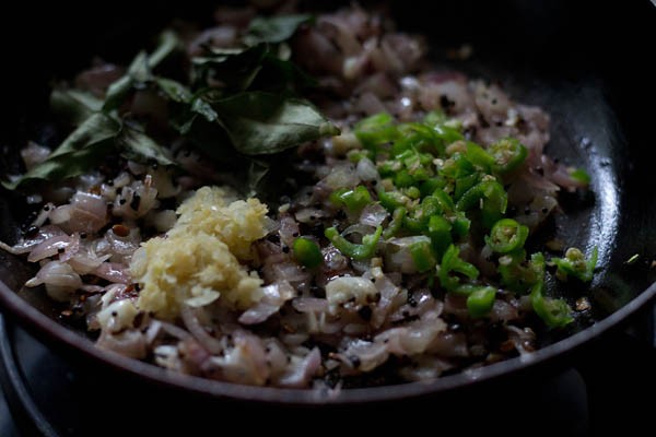 ginger garlic paste, curry leaves and finely chopped green chilies added to the pan for aloo bonda recipe. 