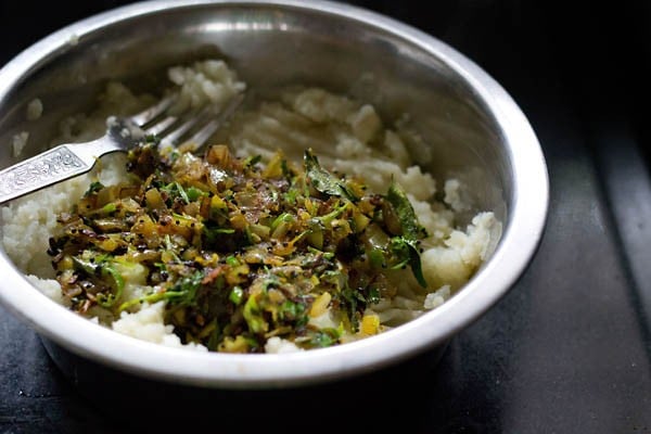 sautéed mixture added to mashed potatoes for aloo bonda recipe. 