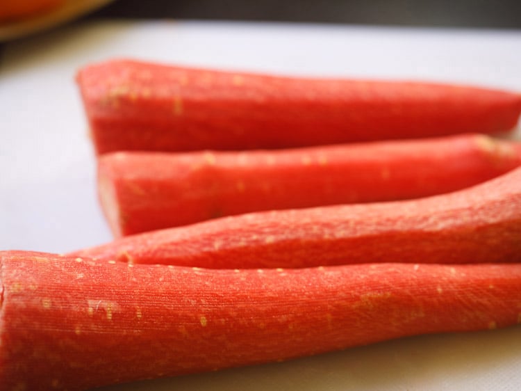 peeled carrots on a cutting board.