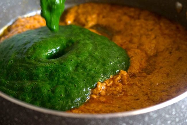adding spinach to the masala curry