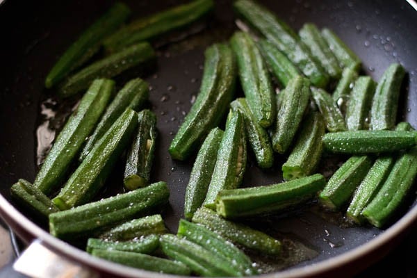 sautéing okra in hot oil in pan. 