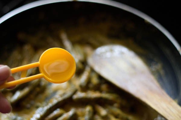 adding water and salt to the besan bhindi. 