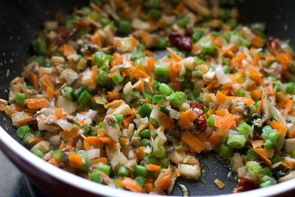 chopped carrots, mushrooms, celery being stir-fried