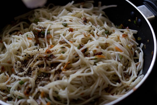 season hakka noodles with salt, crushed black pepper and rice vinegar