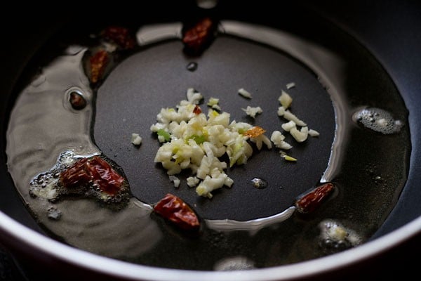 oil, red chillies and finely chopped garlic added to a frying pan